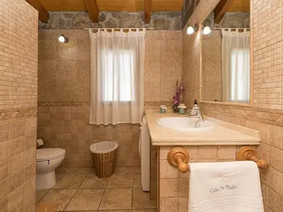a bathroom with a sink and a toilet and a mirror at Holiday Home De Piedra by Interhome in Conil de la Frontera
