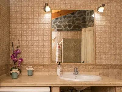 a bathroom with a sink and a mirror at Holiday Home De Piedra by Interhome in Conil de la Frontera