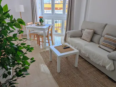 a living room with a couch and a table at Apartamento Costa de la Luz in Chiclana de la Frontera