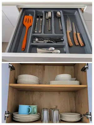 a cabinet with plates and utensils in it at Apartamento Costa de la Luz in Chiclana de la Frontera
