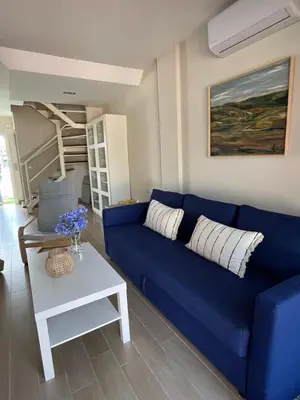 a blue couch in a living room with a table at Casa con encanto El Manatial in El Puerto de Santa María