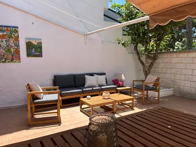 a patio with a couch and a table and chairs at Casa con encanto El Manatial in El Puerto de Santa María