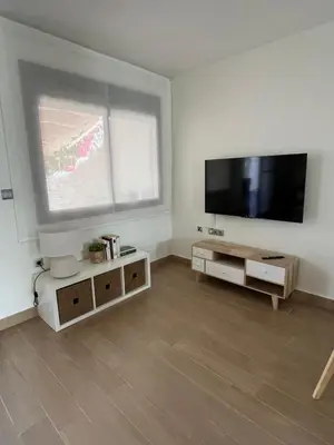 a living room with a large flat screen tv at Casa con encanto El Manatial in El Puerto de Santa María