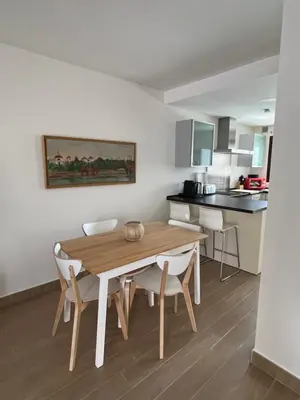 a kitchen and dining room with a wooden table and chairs at Casa con encanto El Manatial in El Puerto de Santa María