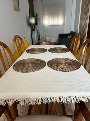 a table with a white table cloth on it at Casa Mariquilla in Sanlúcar de Barrameda