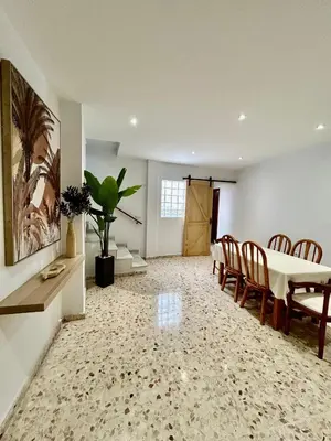 a dining room with a table and some chairs at Casa Mariquilla in Sanlúcar de Barrameda