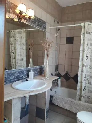 a bathroom with a sink and a toilet and a tub at Casa 1 dormitorio con piscina privada y jardin in Arcos de la Frontera