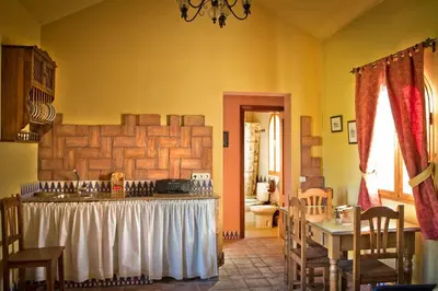 a kitchen with a table in a room at Casa 1 dormitorio con piscina privada y jardin in Arcos de la Frontera