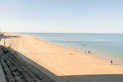 a view of a beach with people walking in the water at Velbar in Cádiz