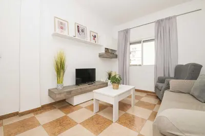 a living room with a couch and a tv at Velbar in Cádiz