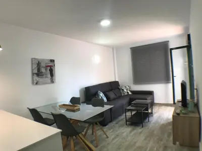 a living room with a couch and a table at Apartmento Apartaclub La Barrosa 223 in Chiclana de la Frontera