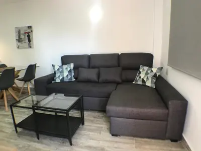 a living room with a couch and a table at Apartmento Apartaclub La Barrosa 223 in Chiclana de la Frontera