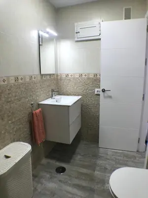 a bathroom with a white sink and a mirror at Apartmento Apartaclub La Barrosa 223 in Chiclana de la Frontera
