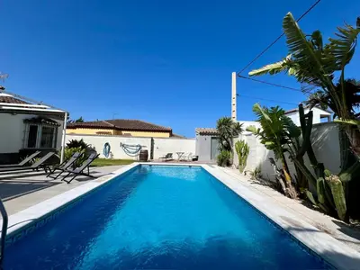 a swimming pool in the backyard of a house at Casa de la Luz in Chiclana de la Frontera