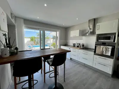 a kitchen with a large wooden table and chairs at Casa de la Luz in Chiclana de la Frontera