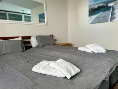 a bed with two white towels on top of it at Casa de la Luz in Chiclana de la Frontera