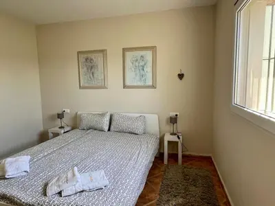 a bedroom with a bed with towels on it at Casa de la Luz in Chiclana de la Frontera