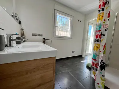 a bathroom with a sink and a shower curtain at Casa de la Luz in Chiclana de la Frontera