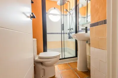 a bathroom with a toilet and a shower and a sink at GuestReady - Calvario Rota 30 JC in Rota