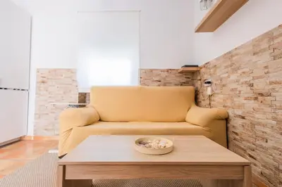 a living room with a couch and a table at GuestReady - Calvario Rota 30 JC in Rota