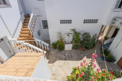 an aerial view of a white building with stairs and flowers at GuestReady - Calvario Rota 30 JC in Rota