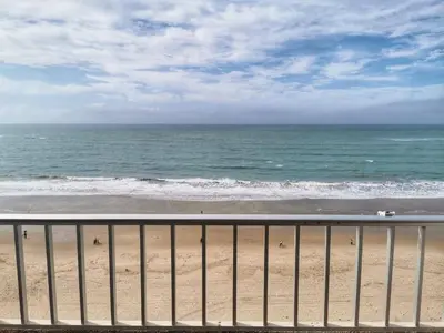 a view of the ocean from a balcony of a beach at Apartamento primera linea de playa in Cádiz