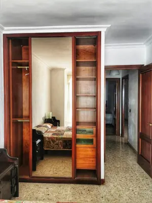 a bedroom with a glass door leading to a bed at Apartamento primera linea de playa in Cádiz