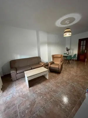a living room with a couch and a table at Barrameda 15 con parking in Sanlúcar de Barrameda