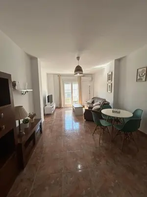 a living room with a couch and a table at Barrameda 15 con parking in Sanlúcar de Barrameda