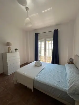 a bedroom with a large bed and a window at Barrameda 15 con parking in Sanlúcar de Barrameda