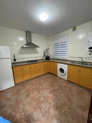 a kitchen with a refrigerator and a washing machine at Barrameda 15 con parking in Sanlúcar de Barrameda
