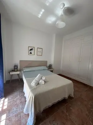 a bedroom with a bed with two towels on it at Barrameda 15 con parking in Sanlúcar de Barrameda