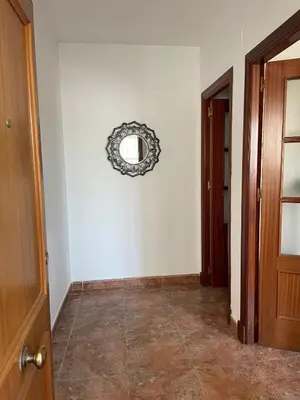 a hallway with a round mirror on the wall at Barrameda 15 con parking in Sanlúcar de Barrameda
