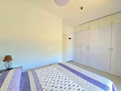 a bedroom with a bed and white cabinets at La almadraba in Chiclana de la Frontera
