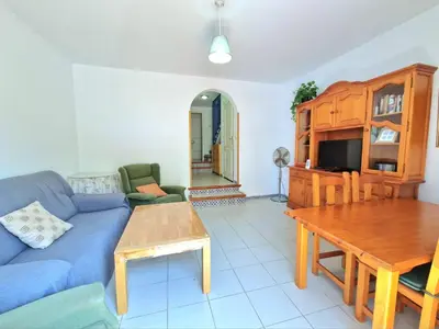 a living room with a blue couch and a table at La almadraba in Chiclana de la Frontera