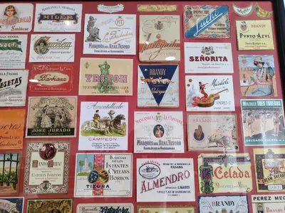a wall with lots of signs on it at High Sanlúcar-Aparcamiento incluído in Sanlúcar de Barrameda