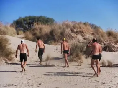 a group of men walking on the beach at High Sanlúcar-Aparcamiento incluído in Sanlúcar de Barrameda