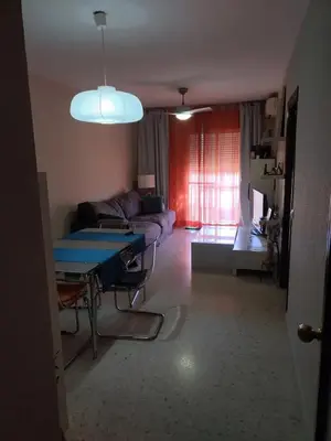 a living room with a table and a couch at High Sanlúcar-Aparcamiento incluído in Sanlúcar de Barrameda