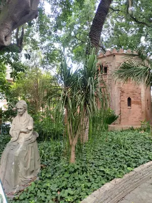 a statue of a woman sitting in a garden at High Sanlúcar-Aparcamiento incluído in Sanlúcar de Barrameda