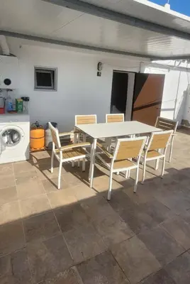 a white table and chairs on a patio at Casa La Retama in La Barca de la Florida