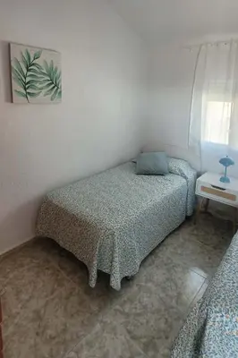 a bedroom with a bed in a white room at Casa La Retama in La Barca de la Florida