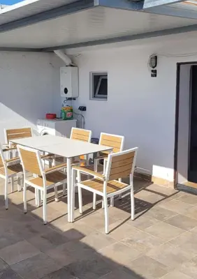 a white table and chairs on a patio at Casa La Retama in La Barca de la Florida