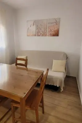 a dining room with a table and a couch at Casa La Retama in La Barca de la Florida