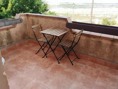 two chairs and a table on a balcony at Apartamentos Jasmund - Estudio 0 in San Fernando