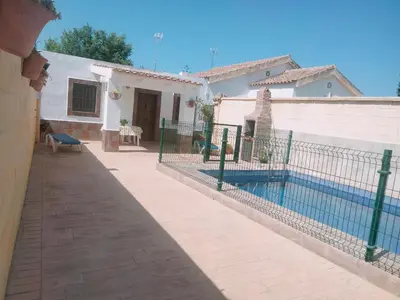 a house with a fence around a swimming pool at Casa rural 1 in Conil de la Frontera