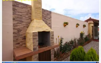 a outdoor pizza oven on the side of a building at Casa rural 1 in Conil de la Frontera
