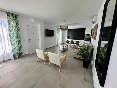 a living room with a couch and chairs and a table at Apartamentos Muñoz Fornell 2 in Chiclana de la Frontera