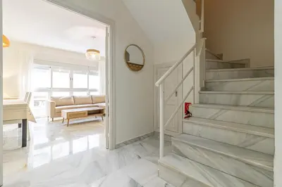 a staircase in a home with a living room at Allo Apartments Medina Duplex Parking 3 Habitaciones in Jerez de la Frontera