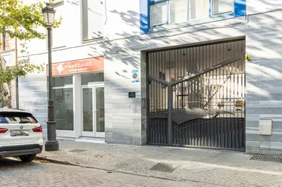 a building with a gate on the side of a street at Allo Apartments Medina Duplex Parking 3 Habitaciones in Jerez de la Frontera