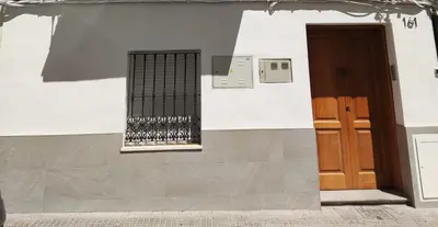 a white building with a window and a door at Casa Bakio in Sanlúcar de Barrameda